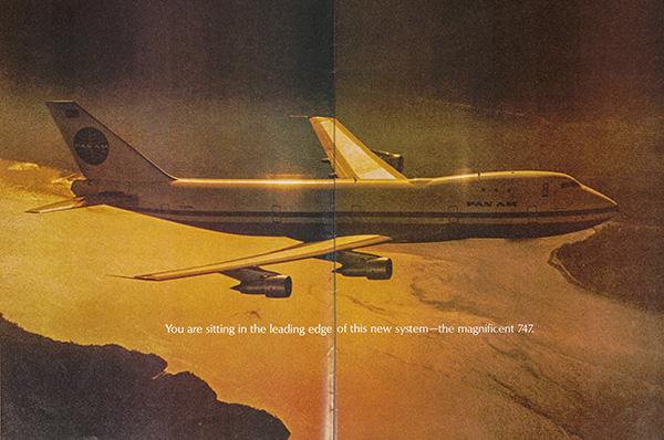 A Pan Am 747 airplane flying over a scenic landscape at sunset, with text that reads 'You are sitting in the leading edge of this new system—the magnificent 747.'