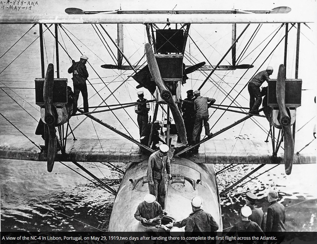 Historical photograph of the NC-4 seaplane in Lisbon, Portugal, on May 29, 1919, with crew members working on the aircraft after completing the first transatlantic flight.